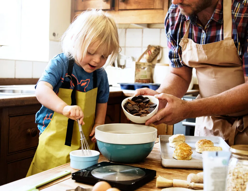 Kid and dad baking