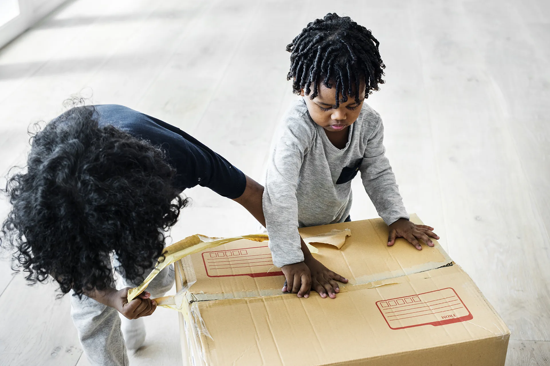 Child helping tape box