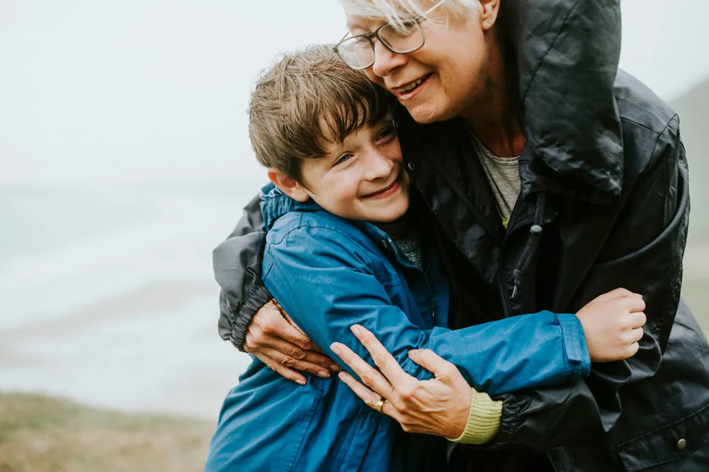 Grandparent hugging grandchild