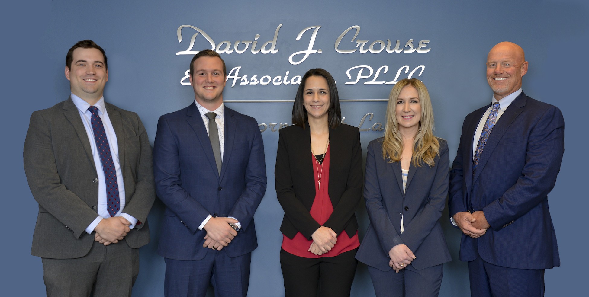 Image of David J. Crouse & Associates Team in front of logo
