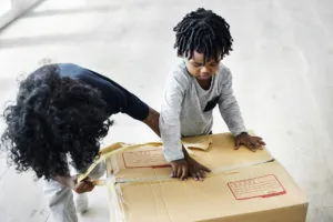 Child helping tape boxes