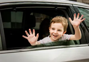 Boy in Car Cheerful Smiling Greeting