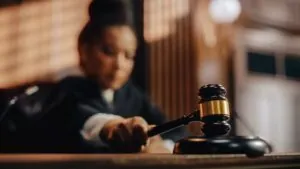 Honorable Female Judge Pronouncing Sentence, striking Gavel. 