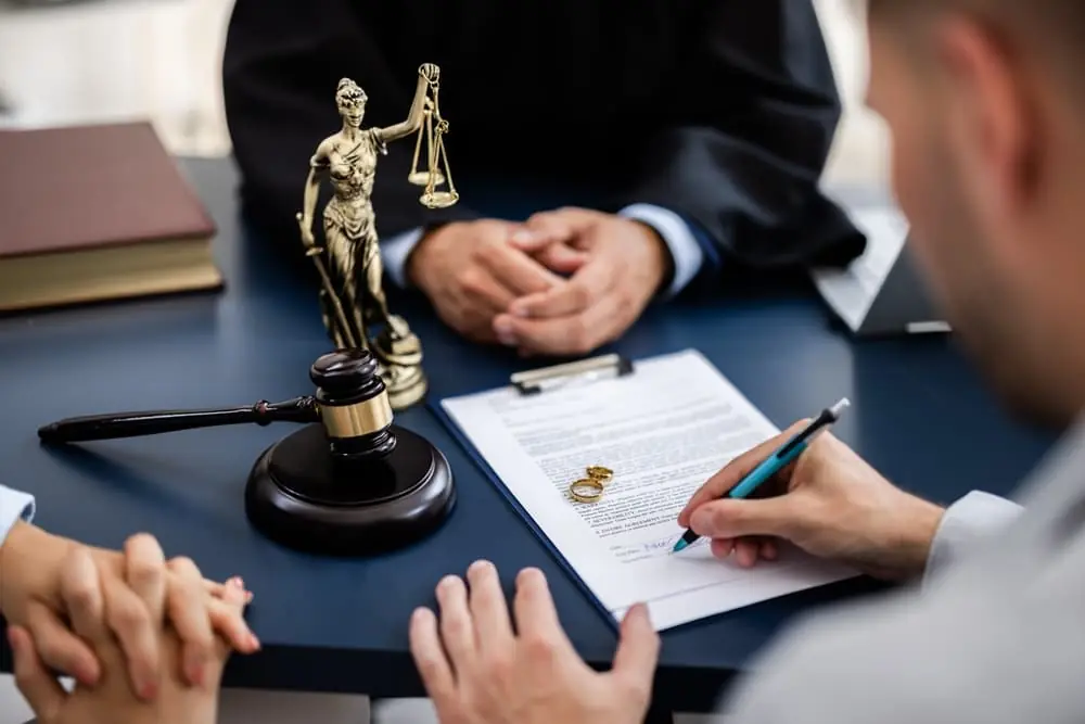 Young couple, consulting with a lawyer in court to sign a divorce agreement document. Young couple, consulting with a lawyer in court to sign a divorce agreement document.