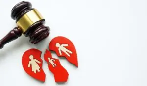 Broken heart with family as a divorce proceeding and a wooden gavel 