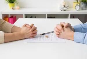 Couple going through divorce or legal separation signing papers